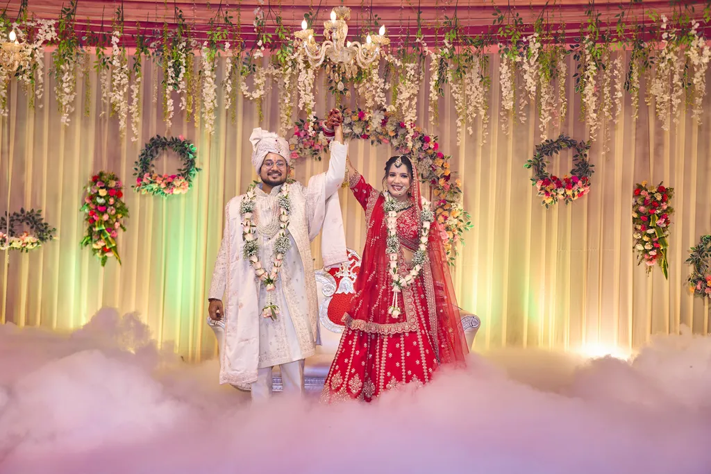 Varmala ceremony with cold fire at Chaudhary Lawn Varanasi wedding by The WeddingShoot